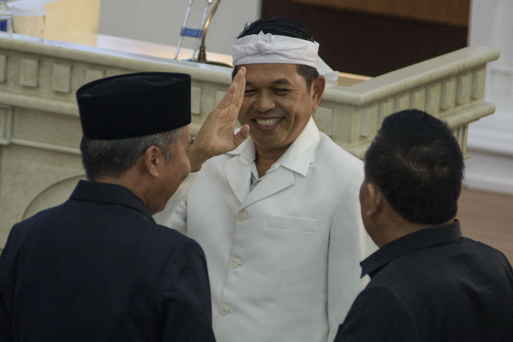 Sparking criticism: West Java governor-elect Dedi Mulyadi (center) salutes on Jan. 10 after a plenary meeting at the West Java Council building to announce the result of the province's regional head elections.