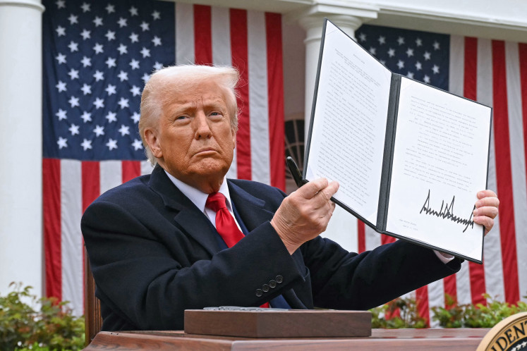 US President Donald Trump holds a signed executive order after delivering remarks on reciprocal tariffs during an event in the Rose Garden entitled “Make America Wealthy Again“ at the White House in Washington, DC, on April 2, 2025.