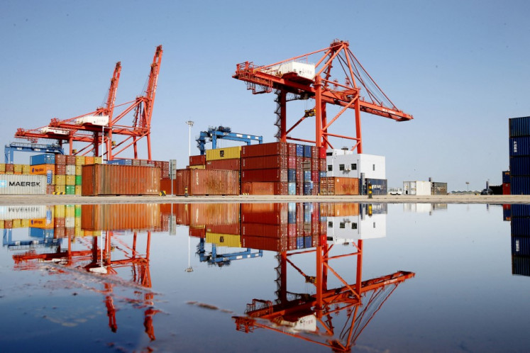 Containers and cranes are seen at the container port in Lianyungang, in China's eastern Jiangsu province on April 13, 2025.