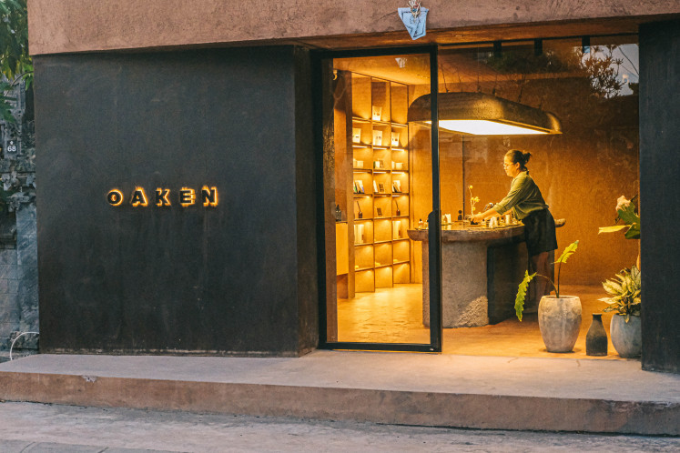A customer explores fragrances at Oaken Lab's artisan perfumery in Pererenan, Bali.