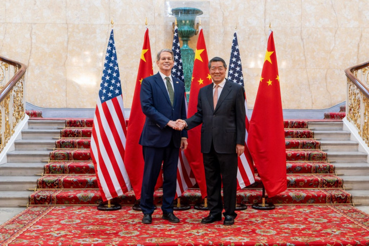 US Secretary of Treasury Scott Bessent (left) and Chinese Vice Premier He Lifeng shake hands as they pose for a photo during trade discussions at the Lancaster House in London on June 9, 2025. 