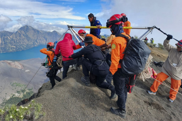 Treacherous mission: Rescue workers on Monday attempt to evacuate Juliana Marins, a Brazilian national who fell into a ravine on Mount Rinjani, Lombok Island, West Nusa Tenggara, after going missing on June 21.